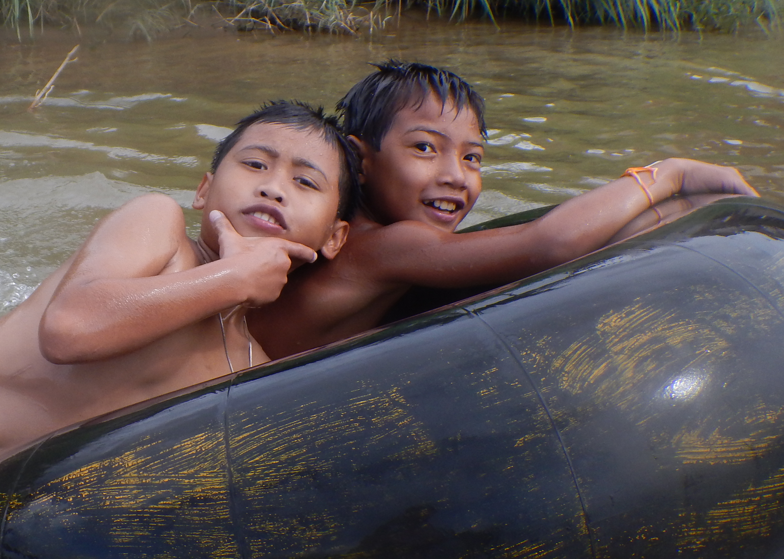 Local boys, floating the Nam Song River in Vang Vieng, Laos