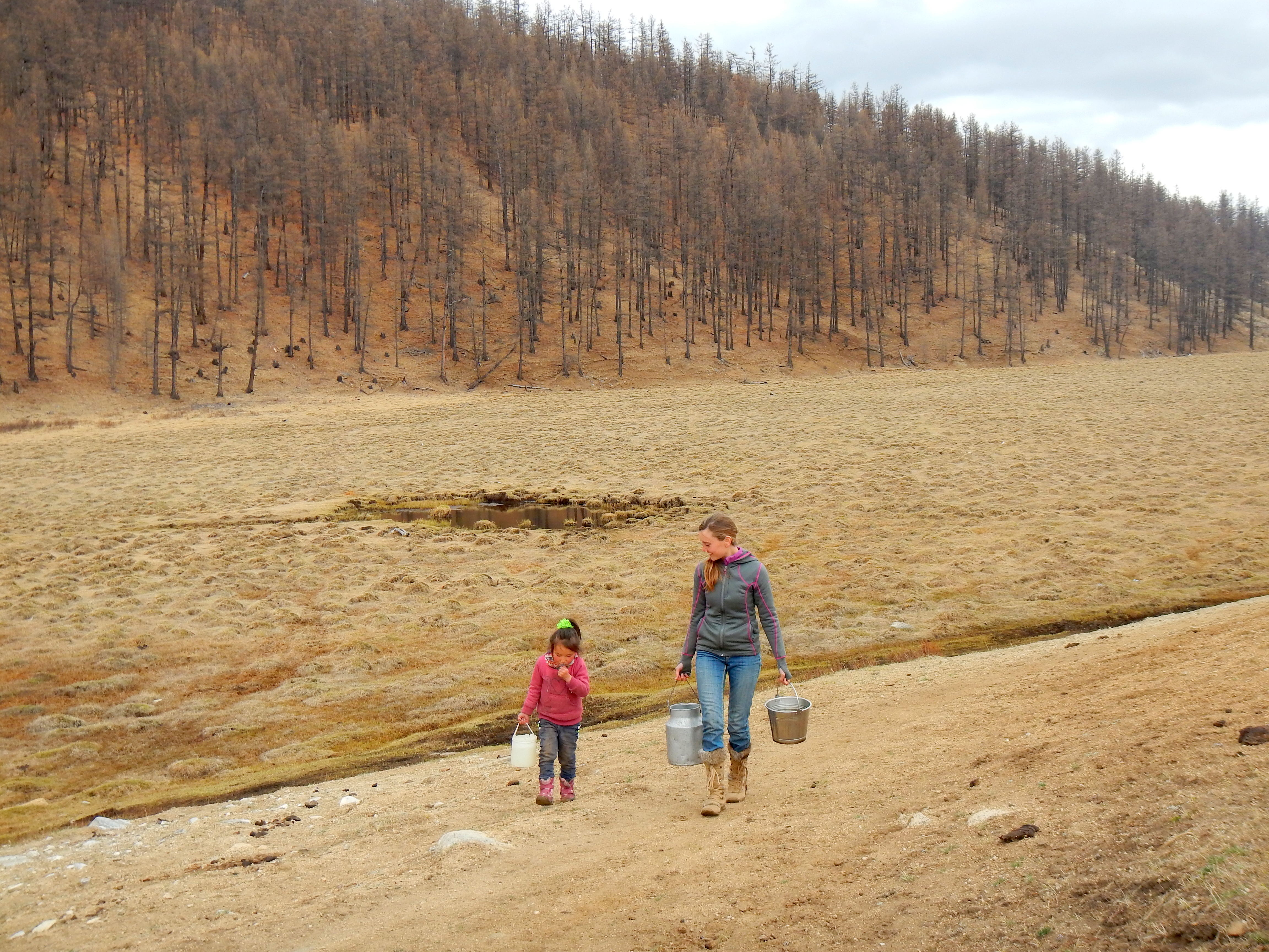 Helping our guide's young daughter fetch water for dinner. Northern Mongolia.