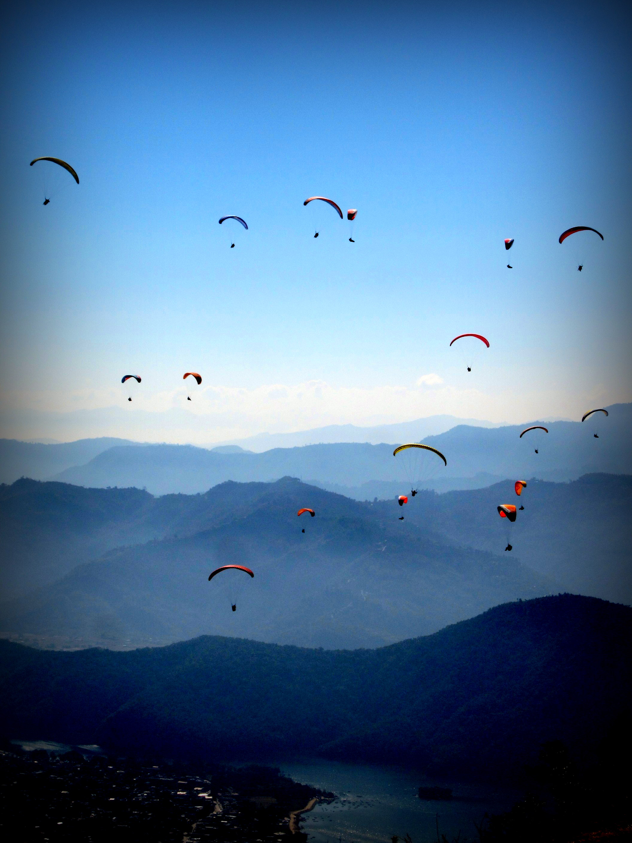 The sky in Pokhara is filled with paragliders-- Flying at the top of the world. Pokhara, Nepal