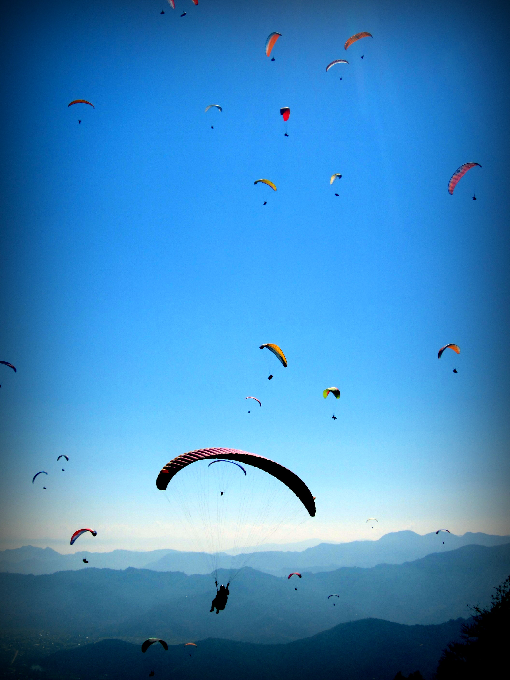 The sky in Pokhara is filled with paragliders-- Flying at the top of the world. Nepal.