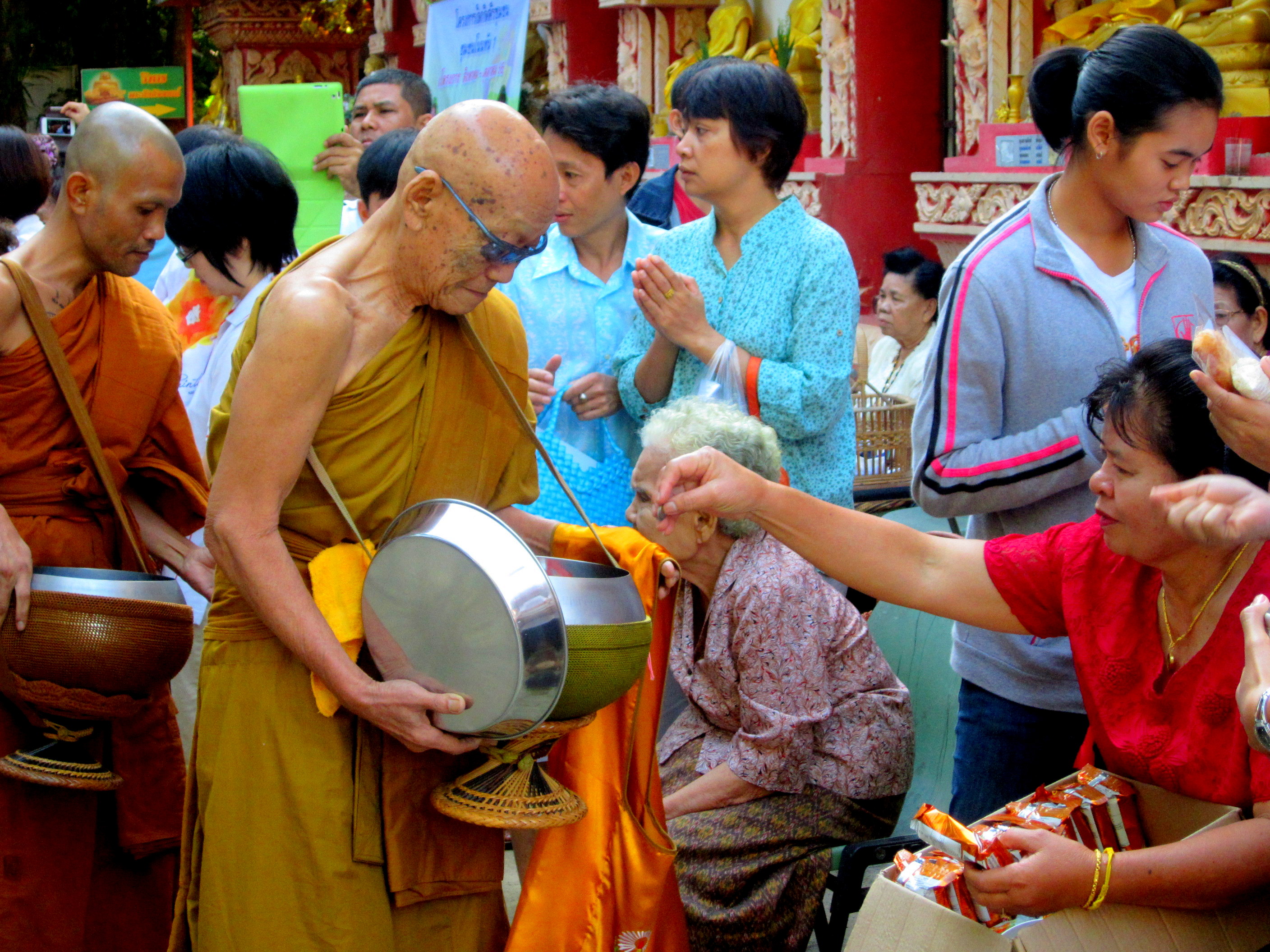 Monks collecting offerings at the Buddhist monastery in Khon Kaen, Thailand