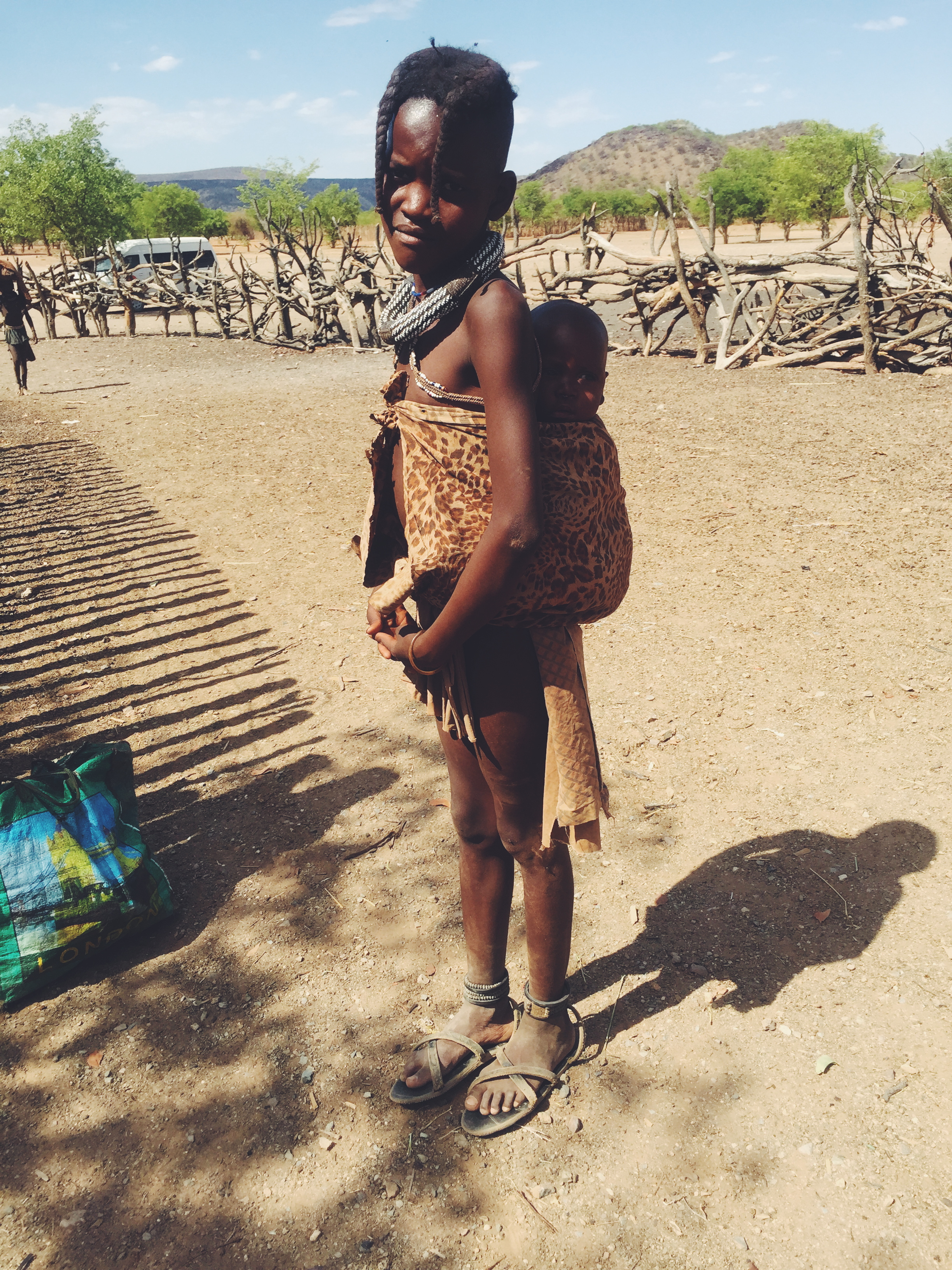 Opuwa, Namibia - Himba tribe. Her name was Ana, and she was watching after her little sister.